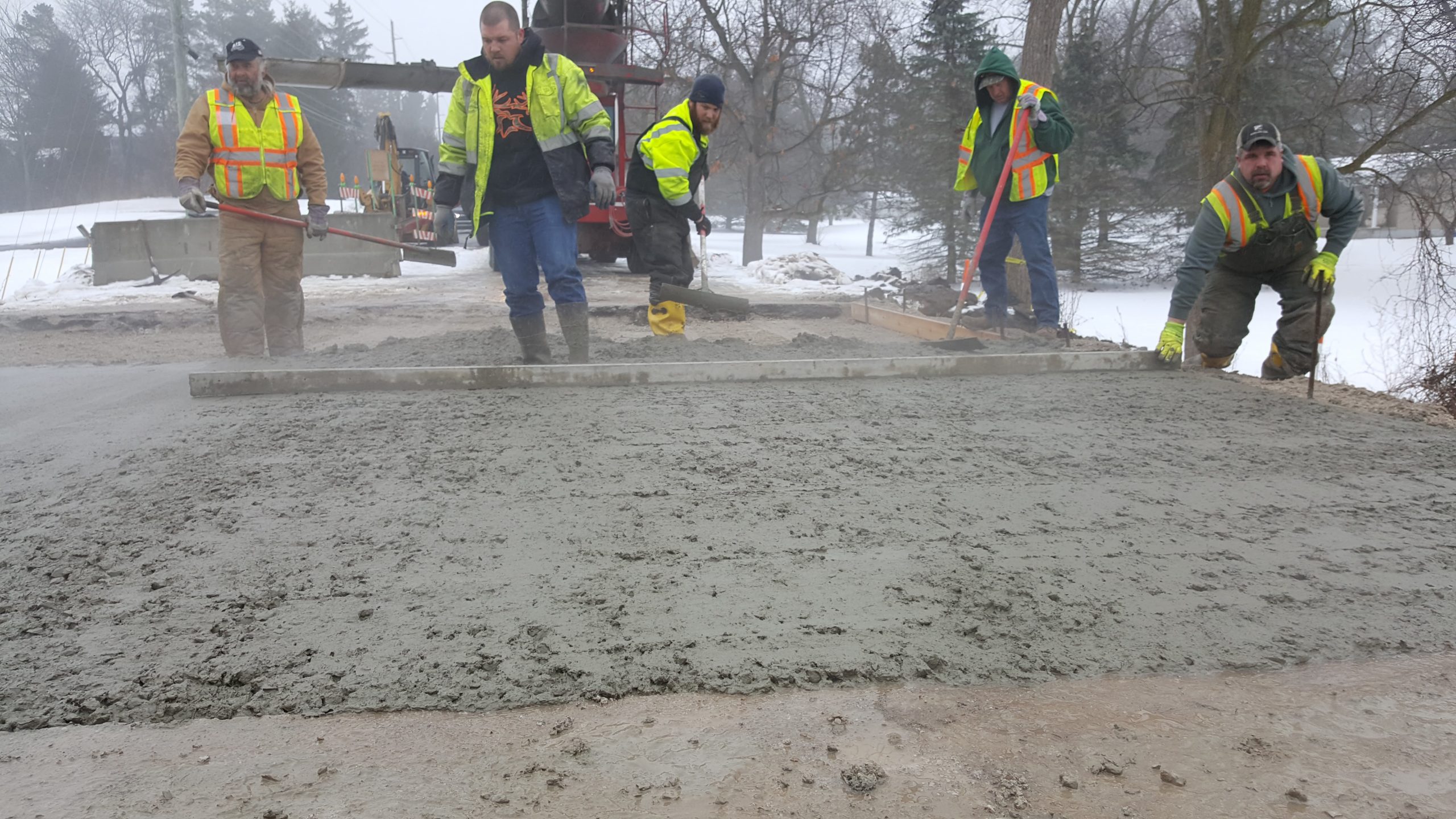 photo of employees pouring concrete