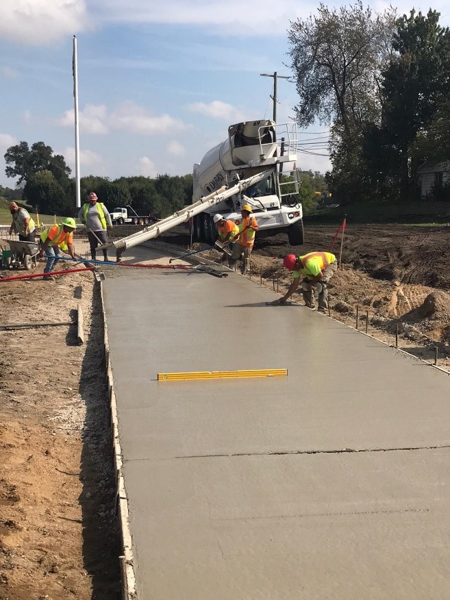 equipment pouring concrete sidewalk on Ecorse Rd