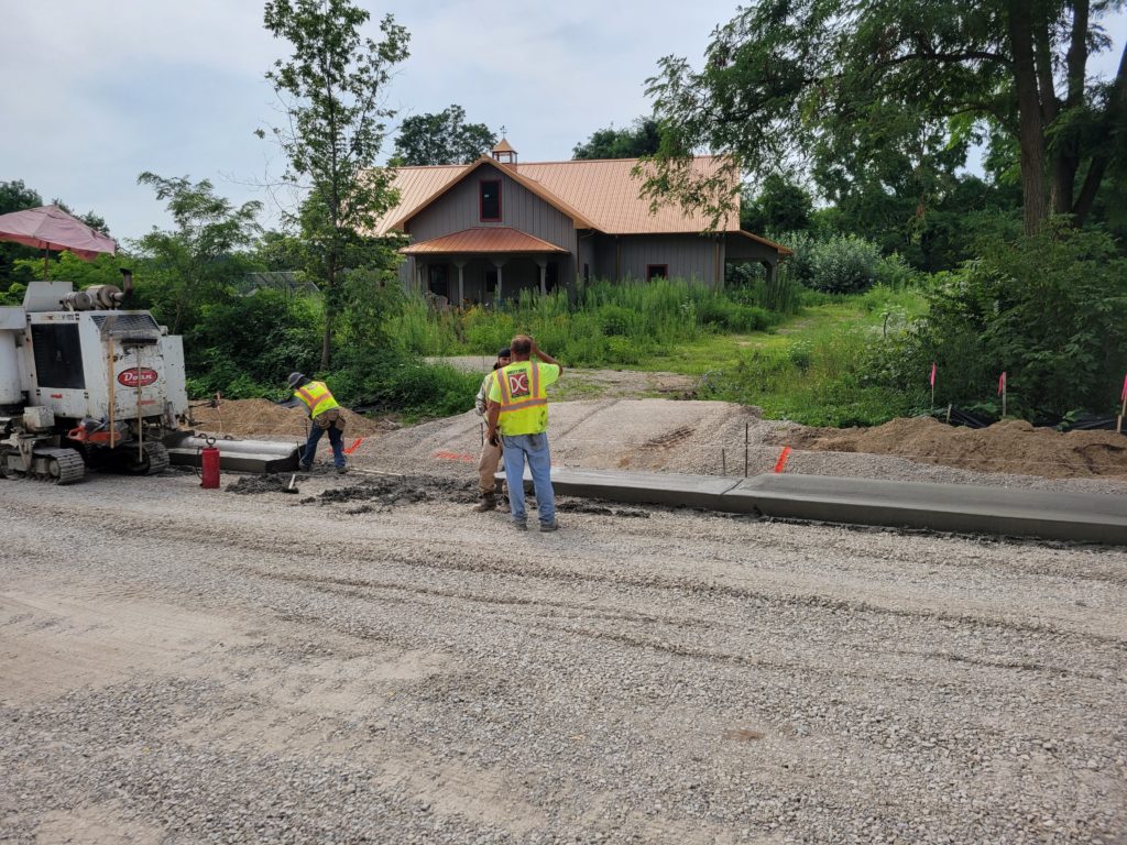 photo of workers placing concrete curb on August 3 in Salem Twp